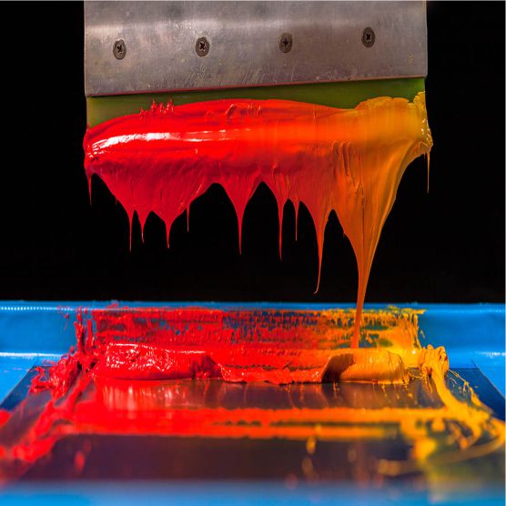 red orange paint on printing press dripping into drip tray